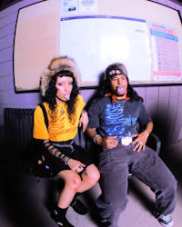 a man and a woman sitting on a bench